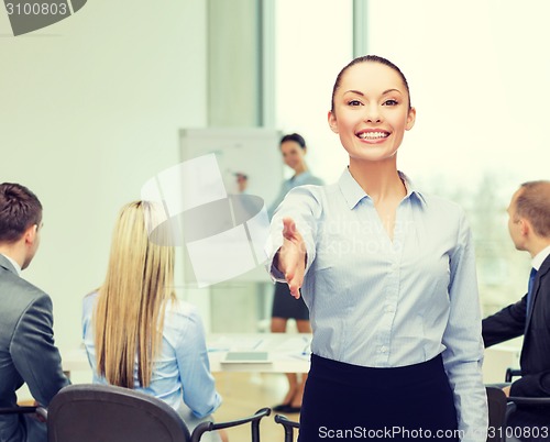 Image of businesswoman with opened hand ready for handshake