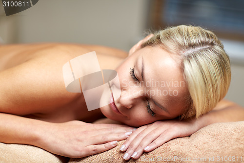 Image of close up of woman lying on massage table in spa