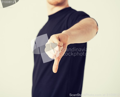 Image of man showing thumbs down