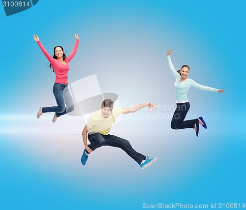 Image of group of smiling teenagers jumping in air