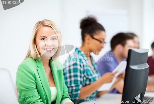 Image of student with computer studying at school