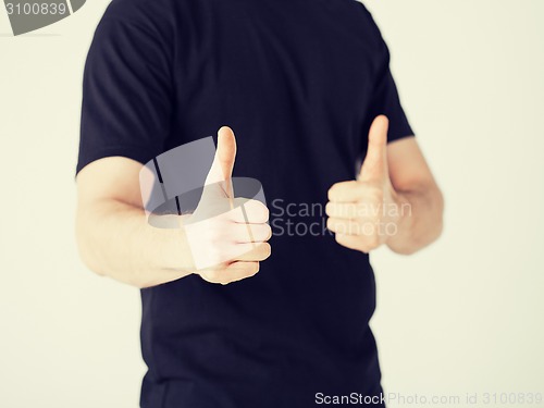 Image of man showing thumbs up