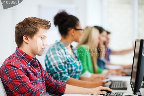 Image of student with computer studying at school