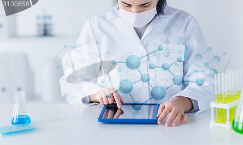 Image of close up of scientist with tablet pc in laboratory