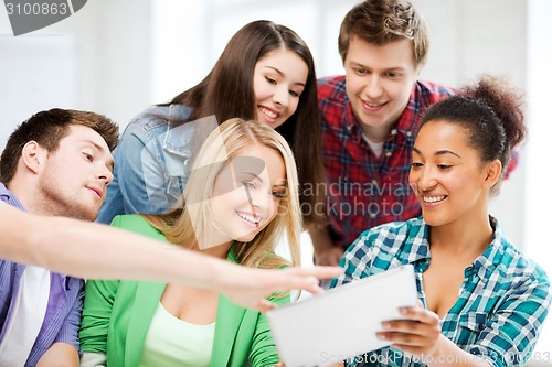 Image of students looking at tablet pc at school