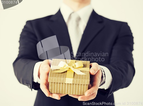 Image of man hands holding gift box