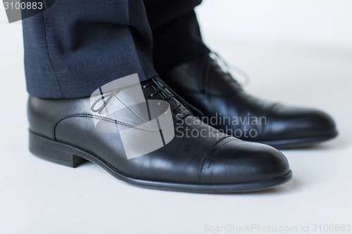 Image of close up of man legs in elegant shoes with laces