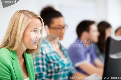 Image of students with computers studying at school