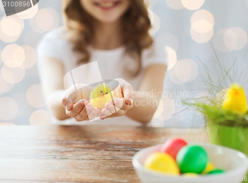 Image of close up of girl holding easter chicken toy