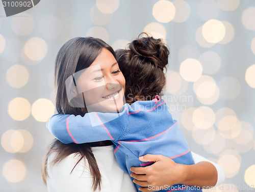 Image of happy mother and daughter hugging