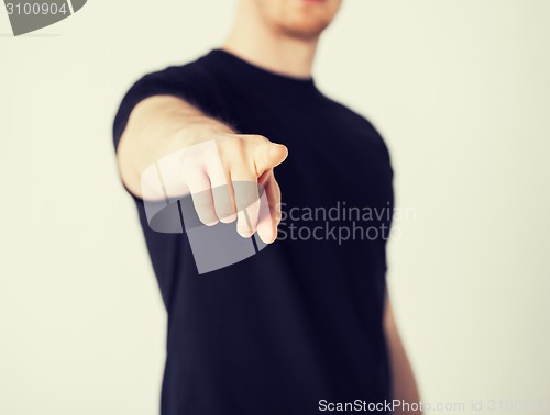 Image of man pointing his finger at you