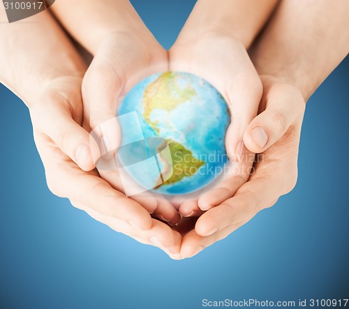 Image of close up of woman and man hands with earth globe