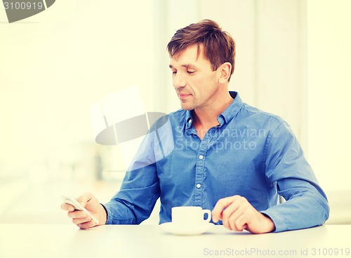 Image of buisnessman with smartphone and cup of coffee