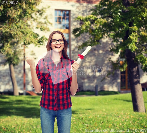 Image of smiling female student in eyeglasses with diploma