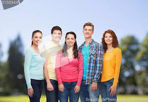 Image of group of smiling teenagers over green park