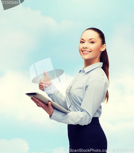 Image of smiling woman looking at tablet pc computer