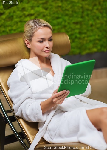 Image of beautiful young woman with smartphone at spa