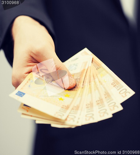 Image of man in suit with euro cash money