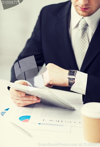 Image of man with tablet pc and cup of coffee