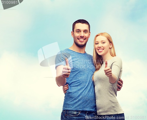 Image of smiling couple showing thumbs up