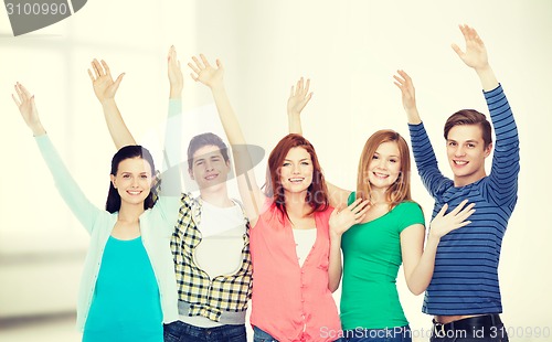 Image of group of smiling students waving hands