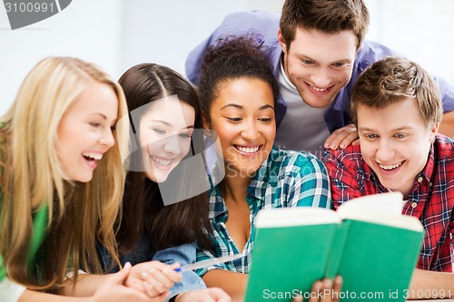 Image of students reading book at school