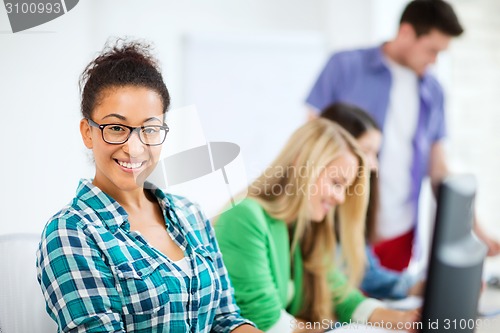 Image of student with computer studying at school