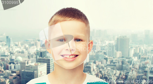 Image of smiling little boy over green background