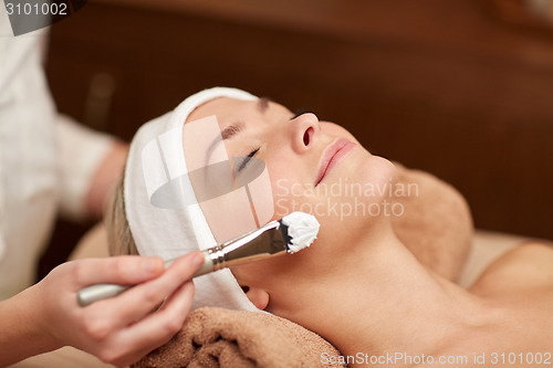 Image of close up of young woman and cosmetologist in spa