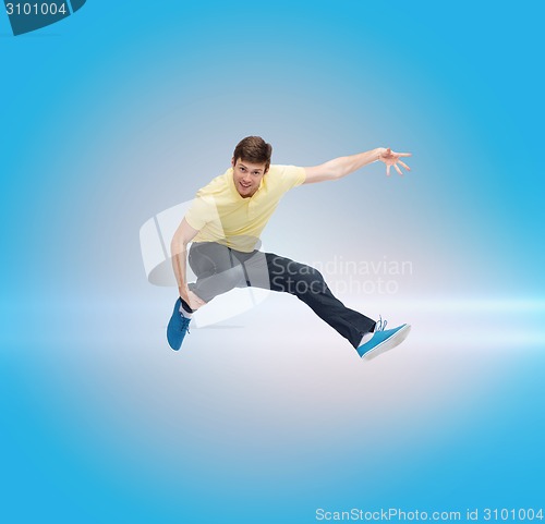 Image of smiling young man jumping in air