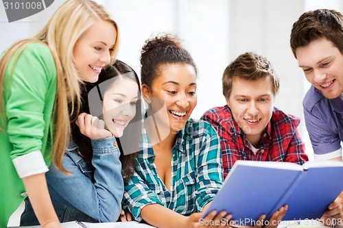 Image of students reading book at school