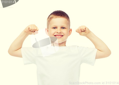 Image of little boy in blank white t-shirt showing muscles