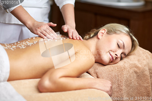 Image of close up of woman lying and having massage in spa