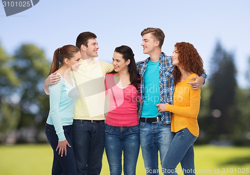 Image of group of smiling teenagers over green park