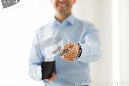 Image of close up of man holding wallet and credit card