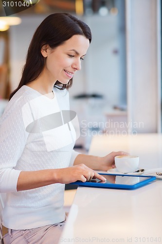 Image of smiling woman with tablet pc and coffee at cafe