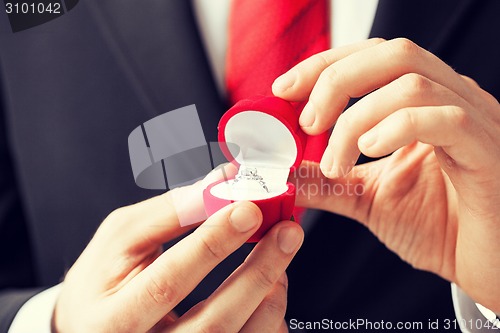 Image of man with wedding ring and gift box