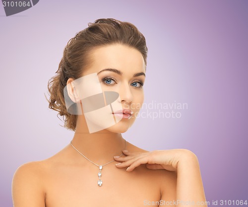Image of beautiful young woman with shiny diamond pendant