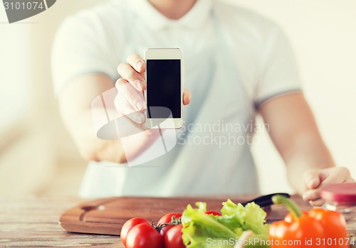 Image of close up of male hands holding smartphone