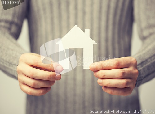 Image of man holding paper house