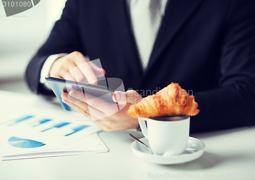 Image of man with tablet pc and cup of coffee