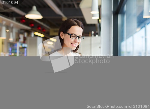 Image of smiling woman with tablet pc at cafe