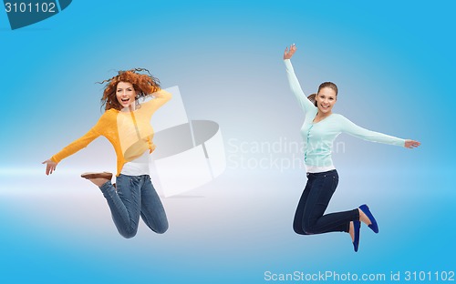 Image of smiling young women jumping in air