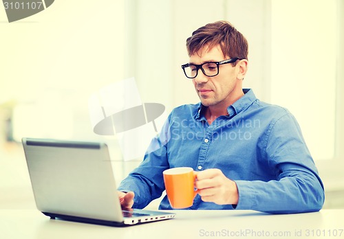 Image of man working with laptop at home