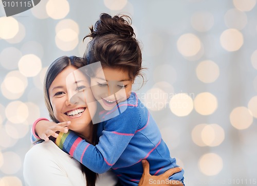 Image of happy mother and daughter hugging