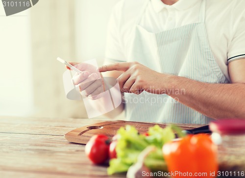 Image of closeup of man pointing finger to smartphone