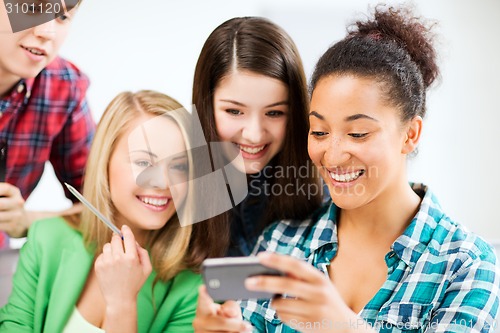 Image of students looking at smartphone at school