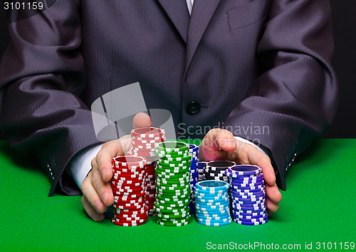 Image of Man puts in the casino. Hand with chips
