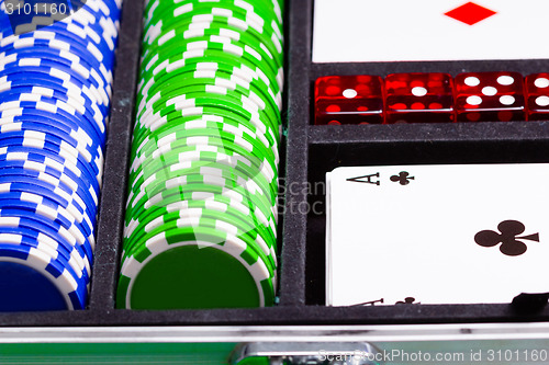 Image of Chips, cards and dice in a suitcase. Set a game