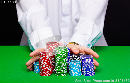 Image of Man puts in the casino. Hand with chips